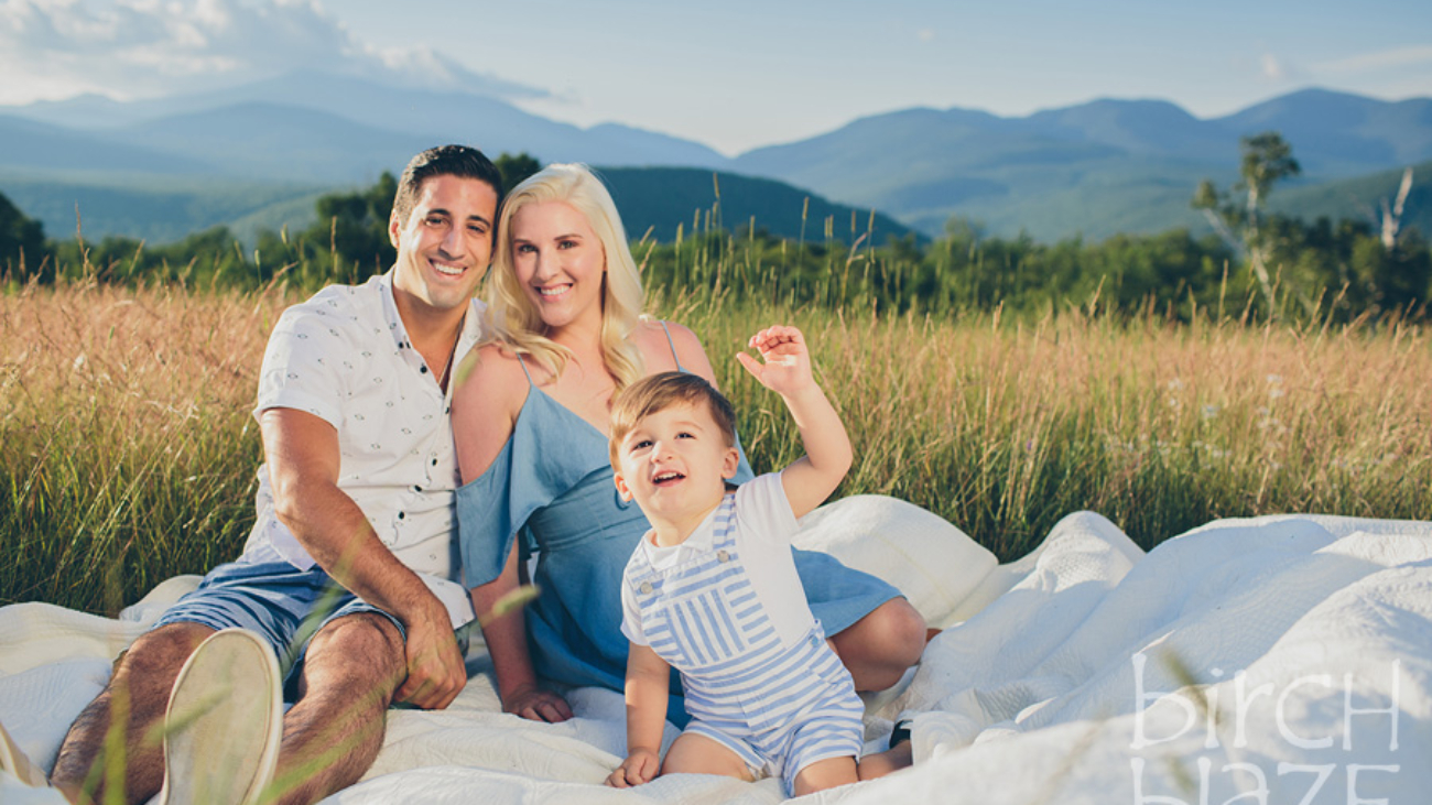 Young family enjoying New Hampshire's White Mountains on a blanket. North Conway Family Photographers, Birch Blaze Studios.