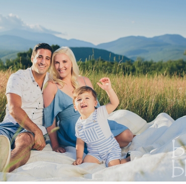 Young family enjoying New Hampshire's White Mountains on a blanket. North Conway Family Photographers, Birch Blaze Studios.
