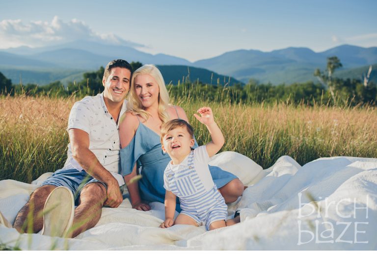 Young family enjoying New Hampshire's White Mountains on a blanket. North Conway Family Photographers, Birch Blaze Studios.