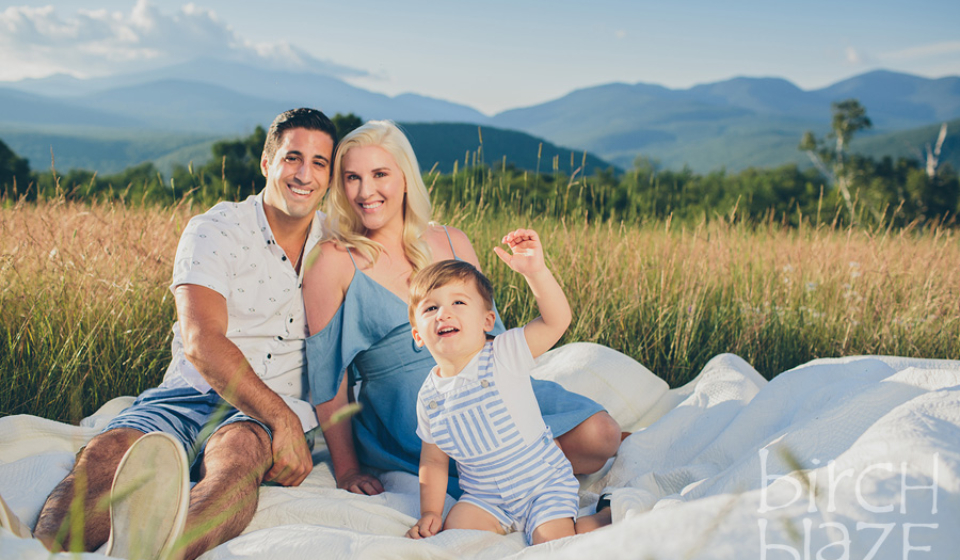 Young family enjoying New Hampshire's White Mountains on a blanket. North Conway Family Photographers, Birch Blaze Studios.
