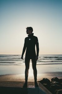 Young surfer portrait at sunrise, east coast. Hero shot. Birch Blaze Studios.