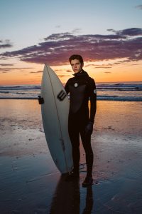 Young surfer portrait at sunrise, east coast. Hero shot.
