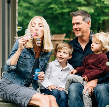 Young family blowing bubbles, Lake Winnipesaukee family photographers, Birch Blaze Studios. Wolfeboro, NH.