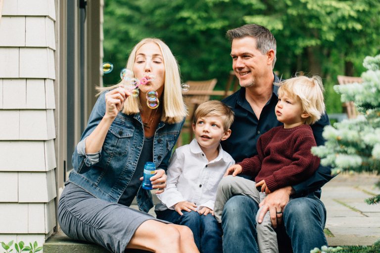 Young family blowing bubbles, Lake Winnipesaukee family photographers, Birch Blaze Studios. Wolfeboro, NH.