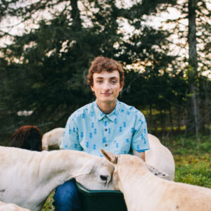 Southern Maine senior photography by Birch Blaze Studios. A young man with his sheep herd in Maine.