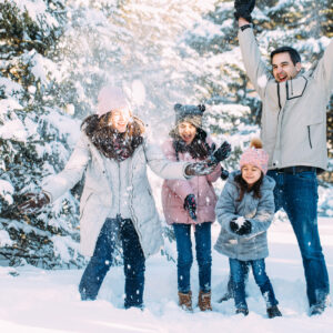 Young family playing in the snow. New Hampshire winter family lifestyle photography session by Birch Blaze Studios. https://birchblaze.com