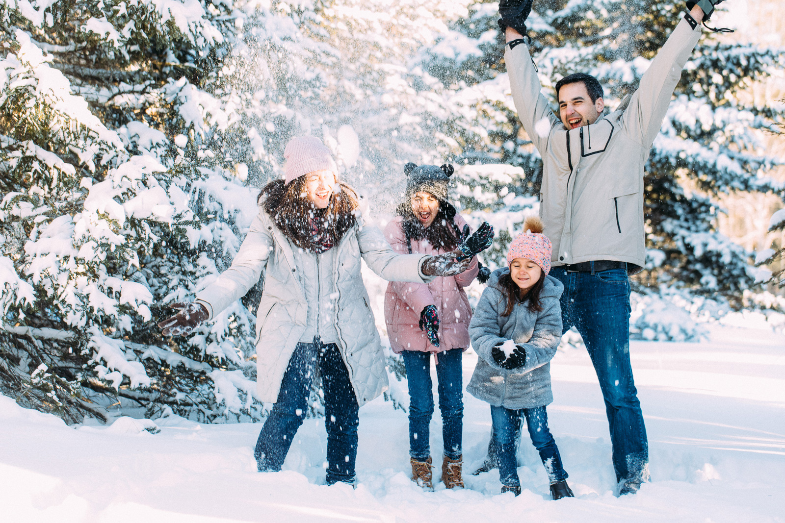 Young family playing in the snow. New Hampshire winter family lifestyle photography session by Birch Blaze Studios. https://birchblaze.com