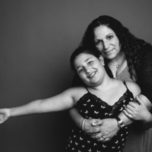 Mother & daughter embracing. Black & White studio photograph by NH family photographers, Birch Blaze Studios.
