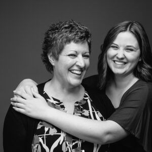 Mother & daughter embracing. Black & White studio photograph by NH family photographers, Birch Blaze Studios.