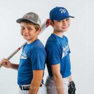 Two young baseball players, youth athletes. Sports portrait created by NH portrait photographers, Birch Blaze Studios. © 2023 Birch Blaze Studios. All Rights Reserved.