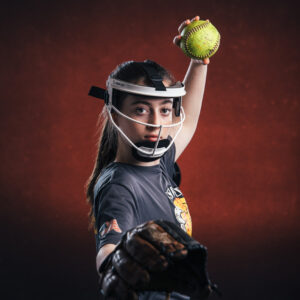 Women's softball player, youth athlete. Sports portrait created by NH portrait photographers, Birch Blaze Studios. © 2023 Birch Blaze Studios. All Rights Reserved.