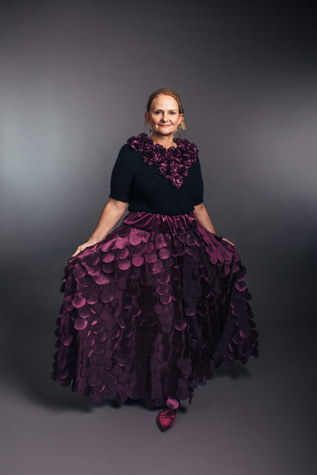 2023 Upcycled Fashion Show portrait by portrait artist, Kerry Struble, of Birch Blaze Studios located in Wakefield, NH. Gorgeous purple skirt with hundreds of handcut circles and matching handmade floral collar, all made from upcycled draderies!