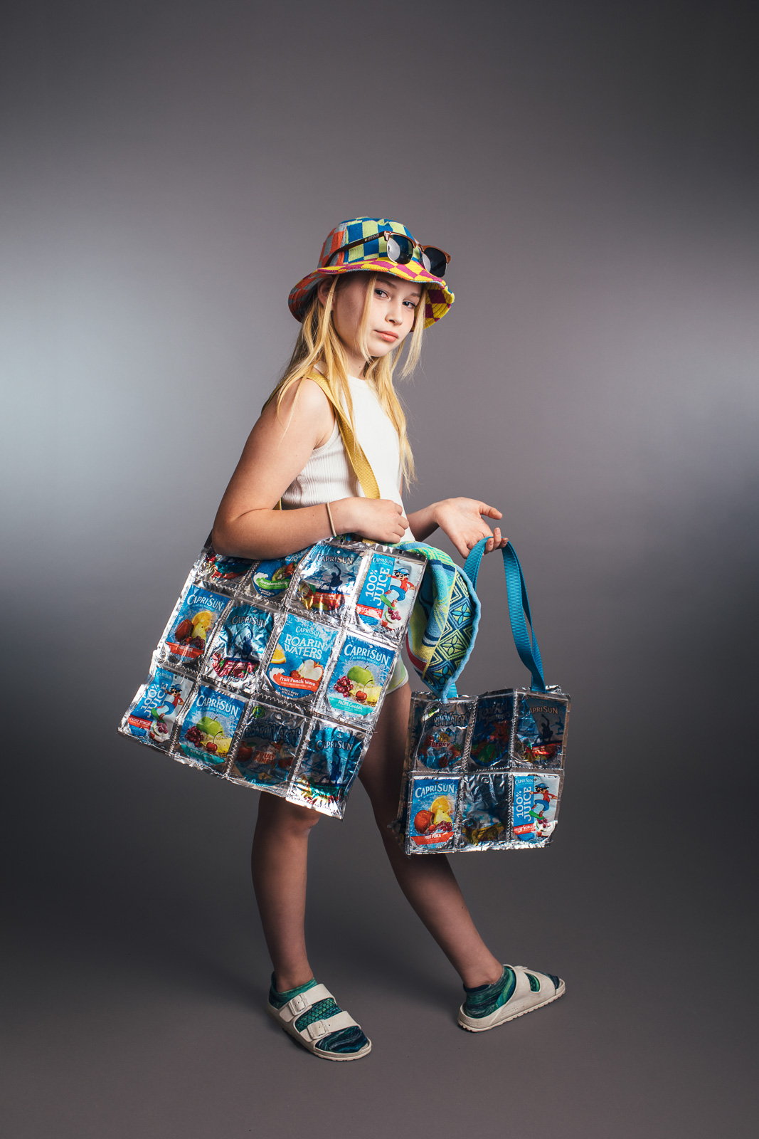 2023 Upcycled Fashion Show portrait by portrait artist, Kerry Struble, of Birch Blaze Studios located in Wakefield, NH. Beach totes handcrafted from empty juice pouches, perfect for a day at the beach!